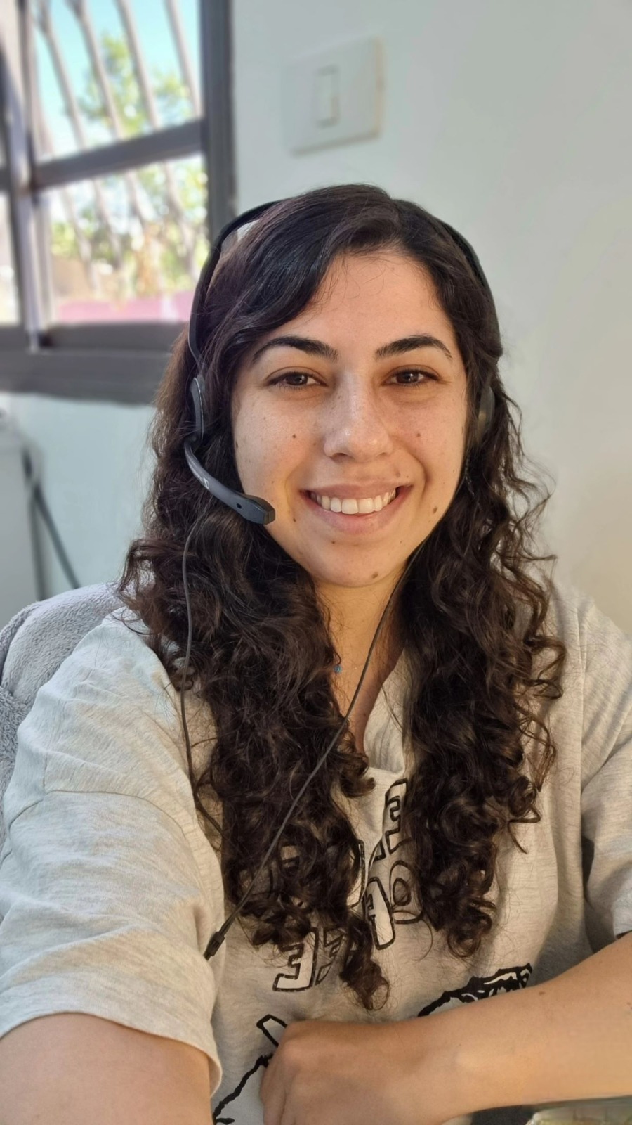 Jessica, native Israeli Hebrew teacher, smiling in a headset